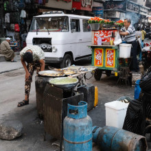 Van zooming past street vendors by Brandon Kim Van zooming past street vendors by Brandon Kim