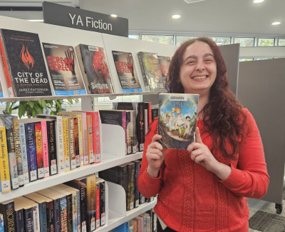 Librarian Carrie holds a copy of The Promised Neverland
