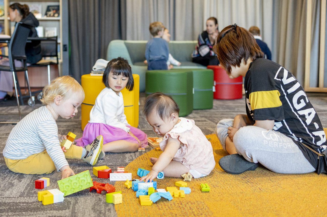 Small children and parents playing with Duplo at Williams Landing