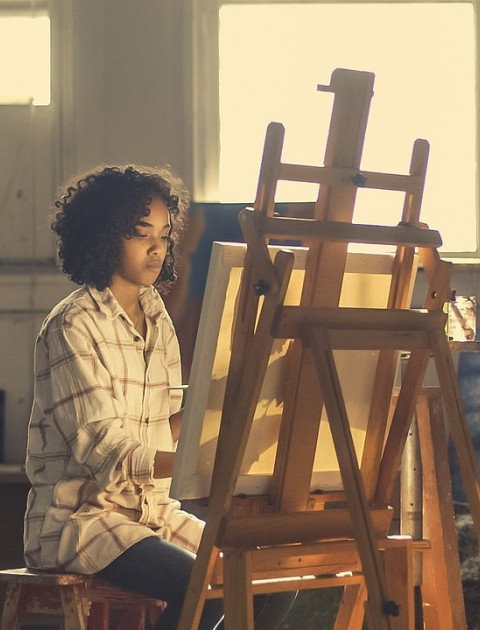 young person with an easel
