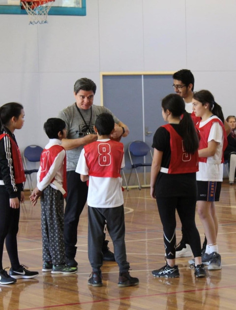 a group of children are listening to their coach
