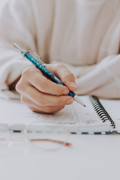 closeup picture of hands writing