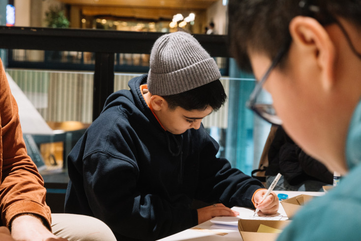 Child drawing at a table.