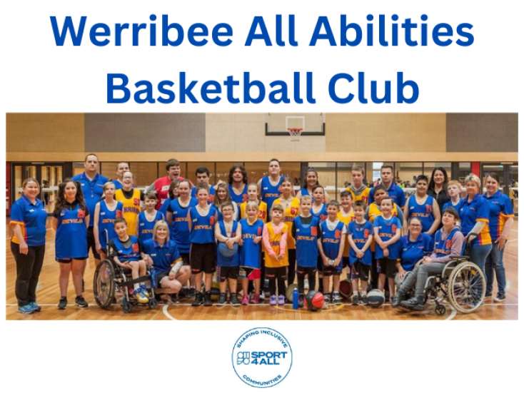 a large group of kids and adults wearing blue basketball kits are smiling at the camera.