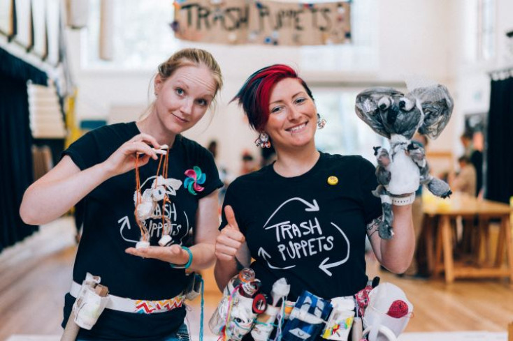 Person holding up puppets made from recyclable items