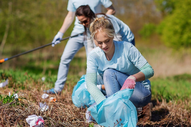 girl picking up rubbish