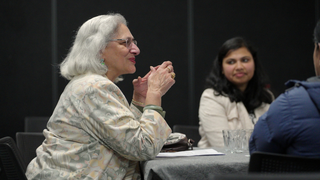 Nawaz, a living book, sits at a table with two other people