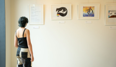 Young person looking at artwork