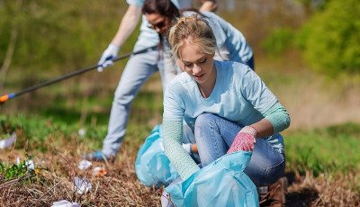 girl picking up rubbish