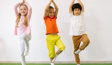 three kids doing yoga