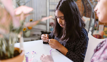 Child making a friendship bracelet