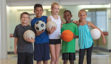 Kids holding sports balls