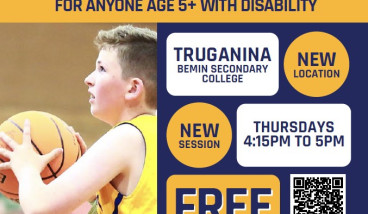 a boy is throwing a ball at a basket